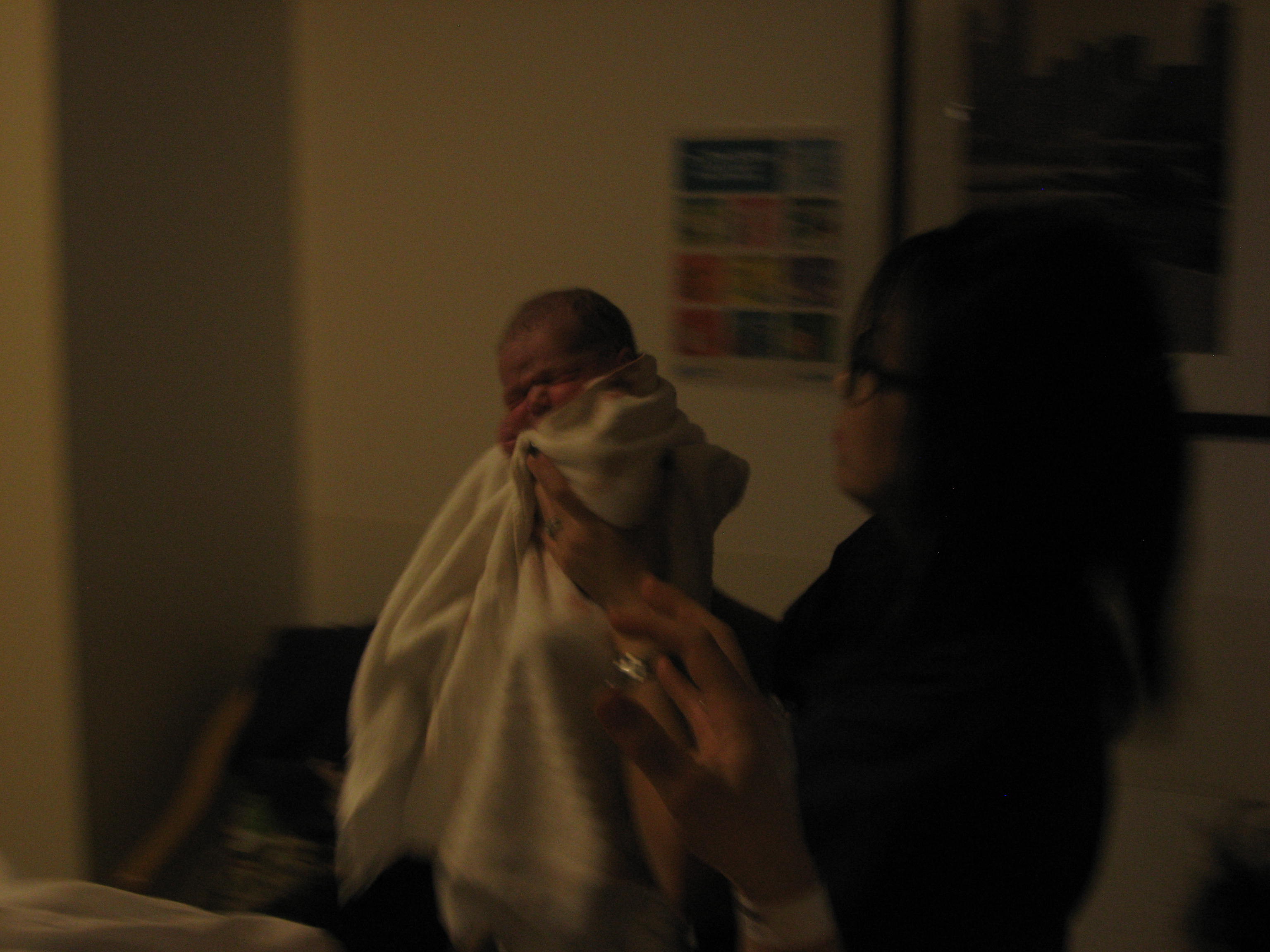 Mother reaches for her son as he takes his first breath